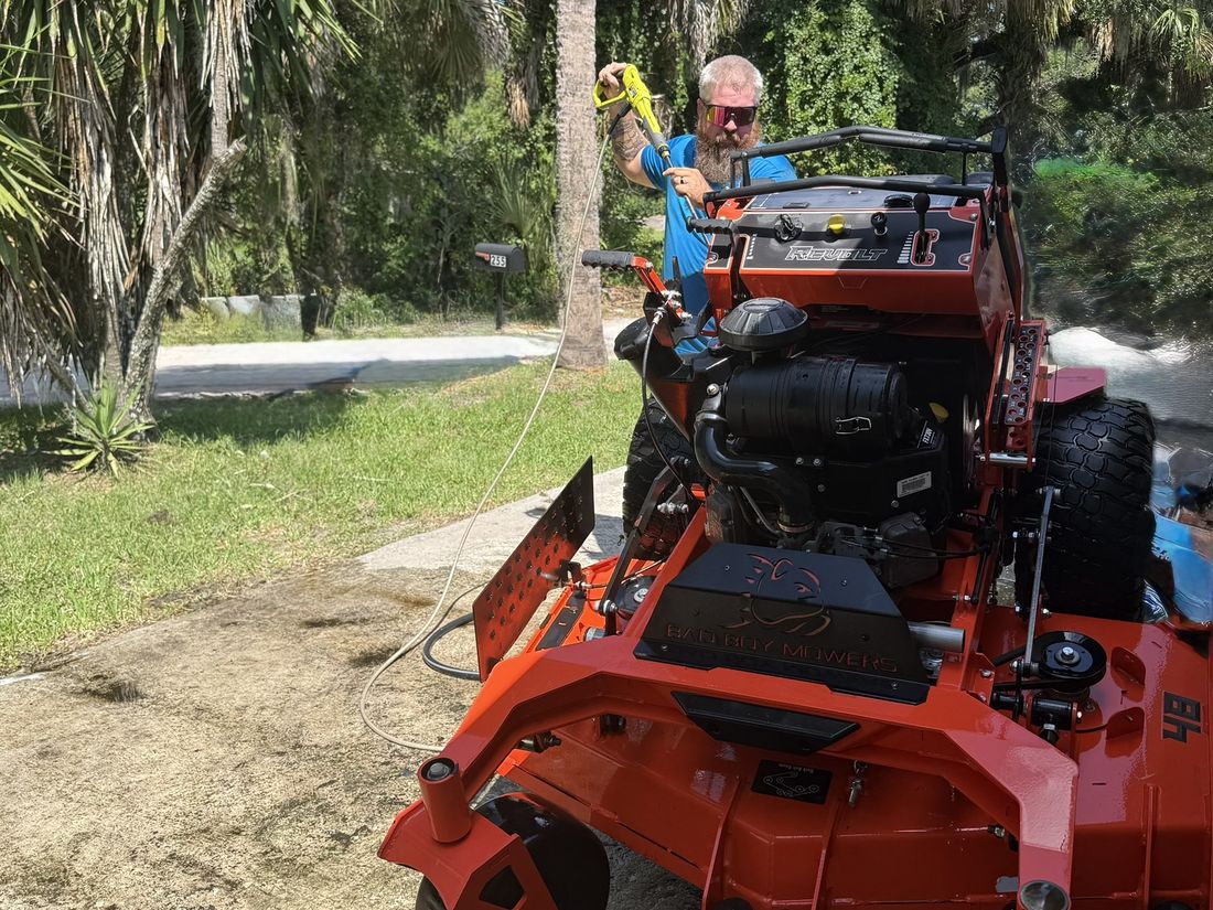 Pressure washing the mower deck clean